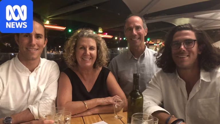 A family of four sitting at a pub or restaurant table